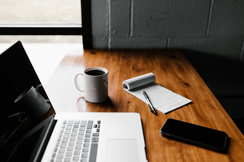 Content marketer using AI writing assistant alongside human editorial review on screen