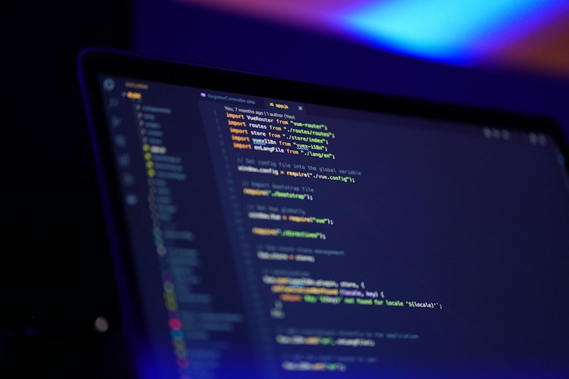Developer building a custom business workflow platform on dual monitor setup