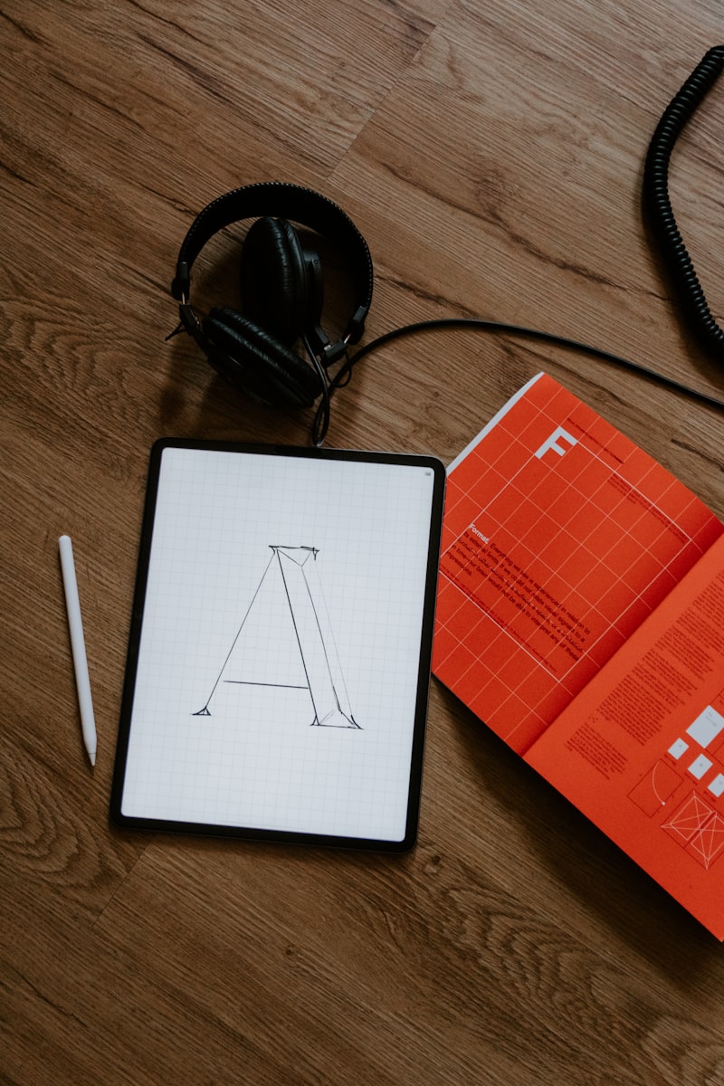 Graphic designer working on brand identity and visual design materials at creative desk