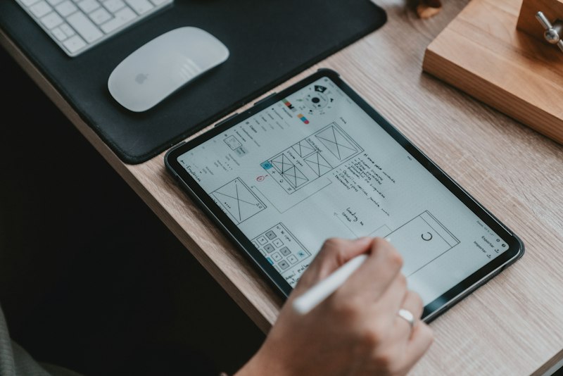 UX designer reviewing user flow diagrams and interface principles on whiteboard
